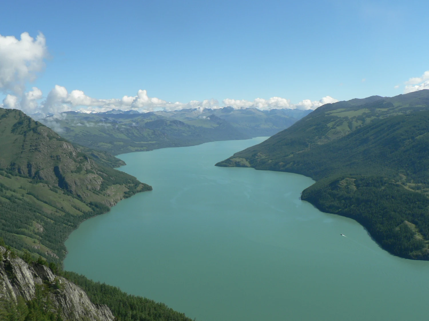 Kanas Lake. Travellers remember its colour; the lake itself belongs to snowmelt, rivers, forests and a much larger mountain system.