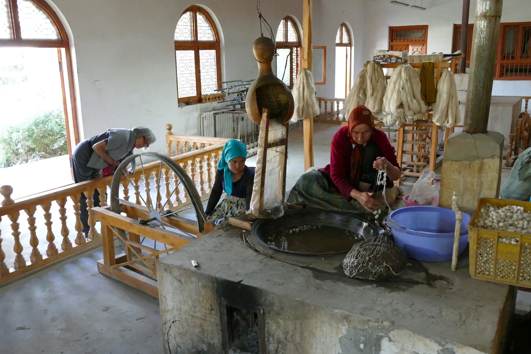 Silk production in Jiya Township near Hotan, 2015. The craft appears here as work taking place in a real workspace rather than as an object behind glass. Photograph: Zossolino, CC BY-SA 4.0.