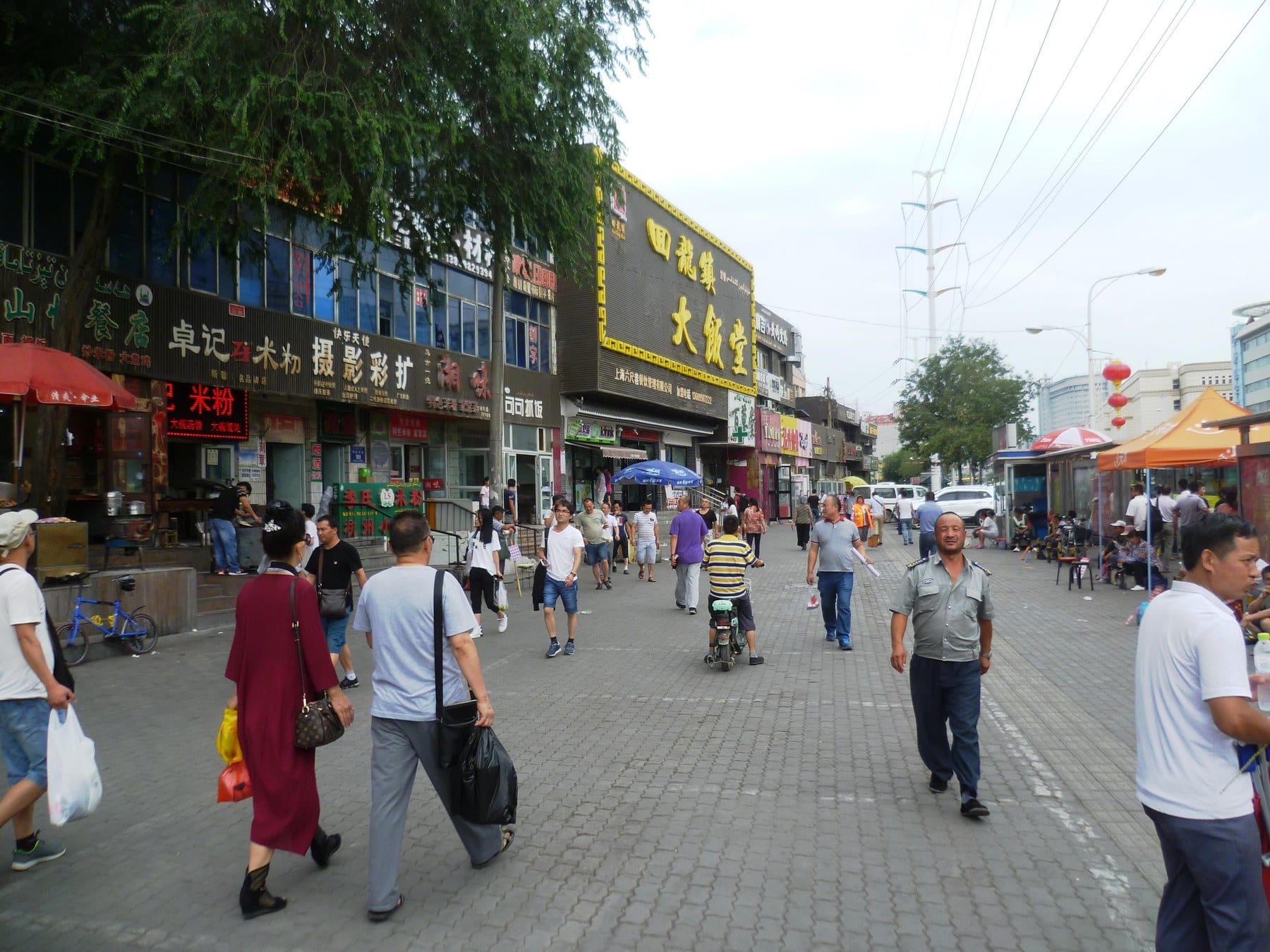 Shops and pedestrians on an ordinary street in Urumqi