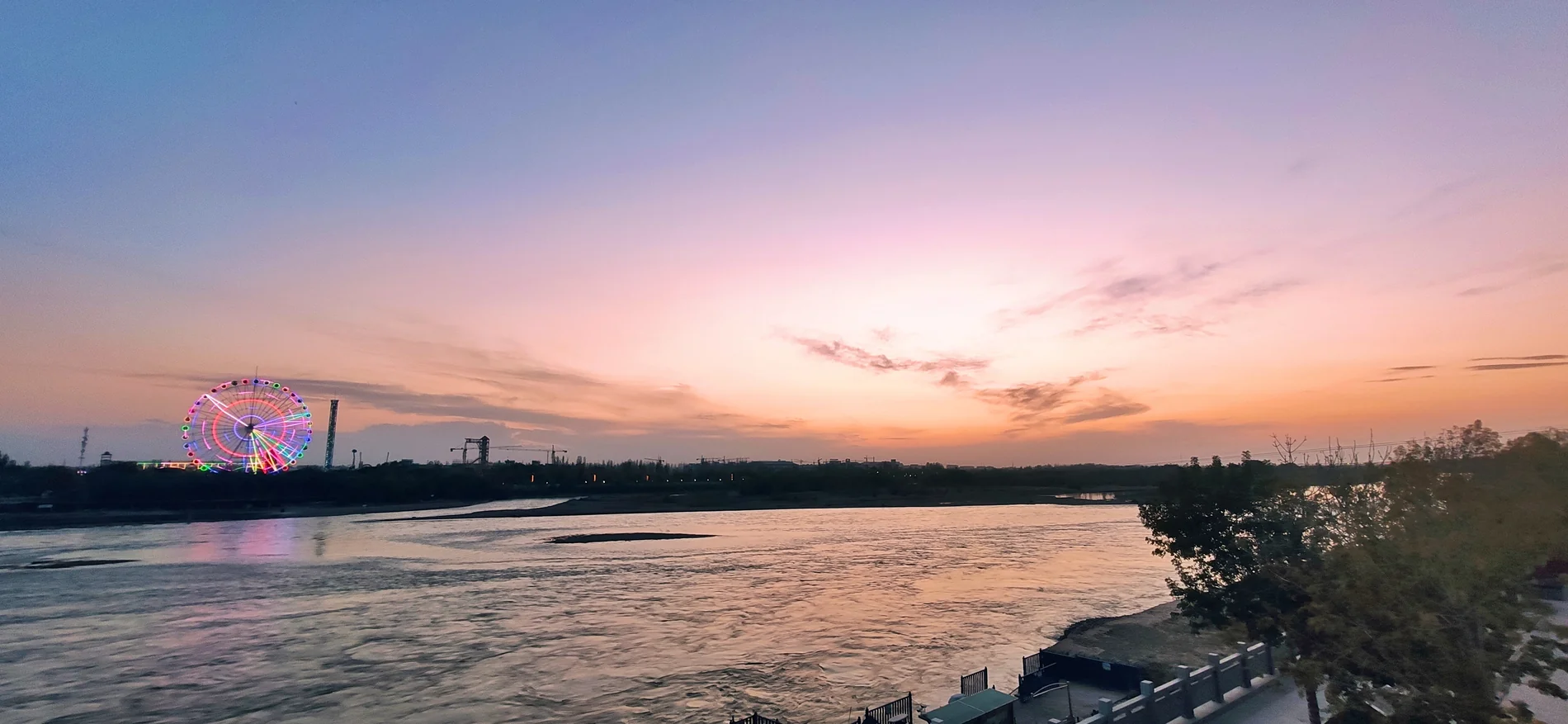 Evening on the Ili River near Yining. The mountain rivers enter a broader plain and connect pastures, fields, cities and routes leading west.