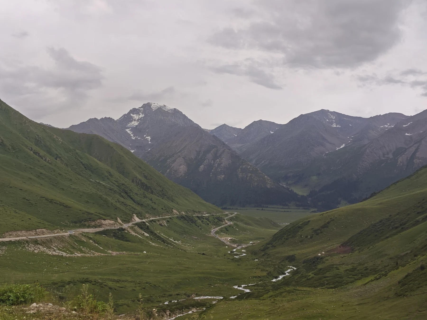 Towards Xinyuan, the valley opens and green replaces the exposed rock. Duku Highway, July 2026.