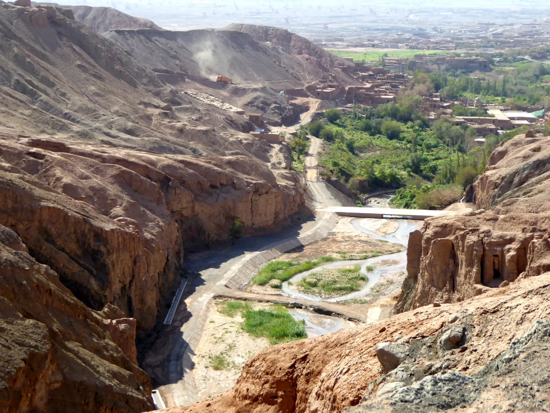 Tuyugou cutting into the Flaming Mountains, with oasis and ravine meeting in Turpan, Xinjiang